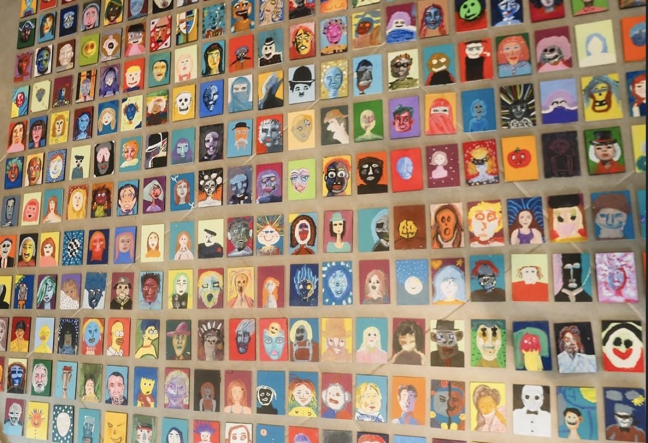 Gente en Obra — muro de retratos pequeños, uno al lado del otro.
